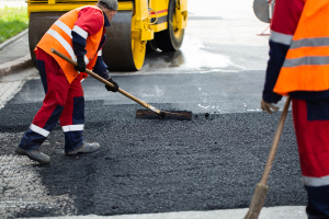 Hardworking man doing road repairs