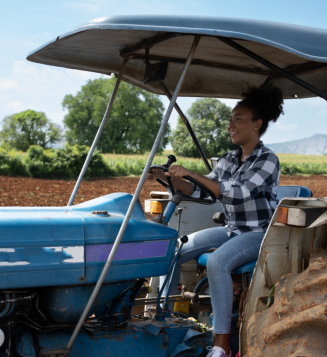 a female person driving a tractor