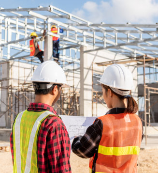 two architect and client discussing help create plan with blueprint home building at construction site