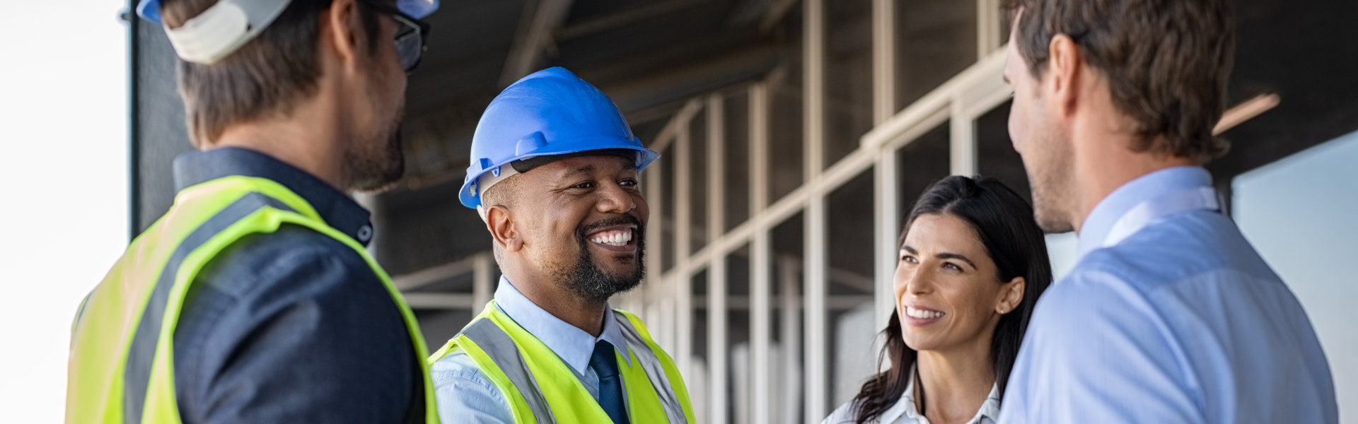 Smiling engineer shaking hands at construction site
