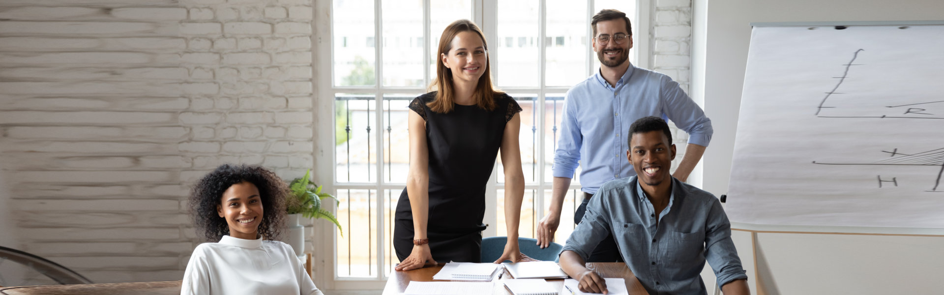 Portrait of happy mixed race motivated successful colleagues